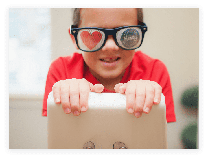 Image of young boy wearing sunglasses depicting the Henry Orthodontics logo