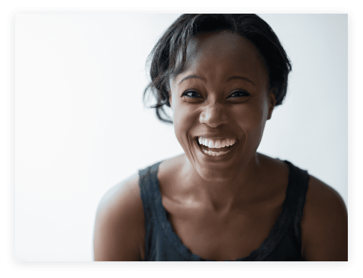 Woman smiling brightly with her hair in a ponytail