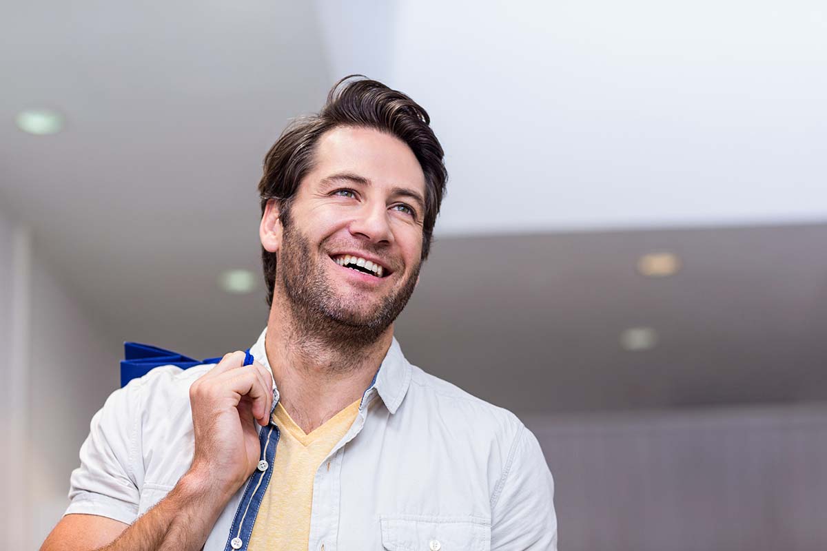 smiling-man-with-shopping-bags Happy woman breathing easier following airway orthodontic treatment in Los Angeles