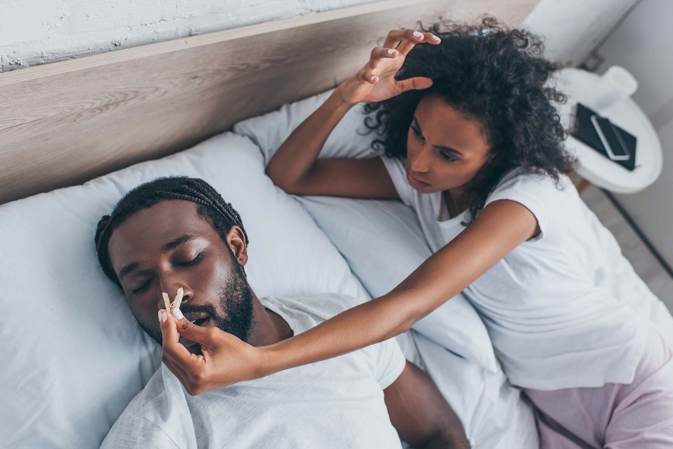 Airway Orthodontics - Gulf Coast Orthodontics young woman pinning the nose of her snoring partner