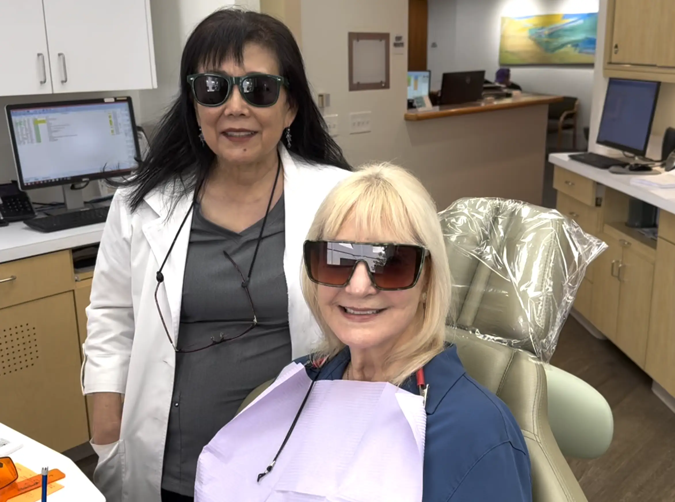 Dr. Hakim, the best orthodontist in Los Angeles, chairside with an orthodontic patient straightening her teeth